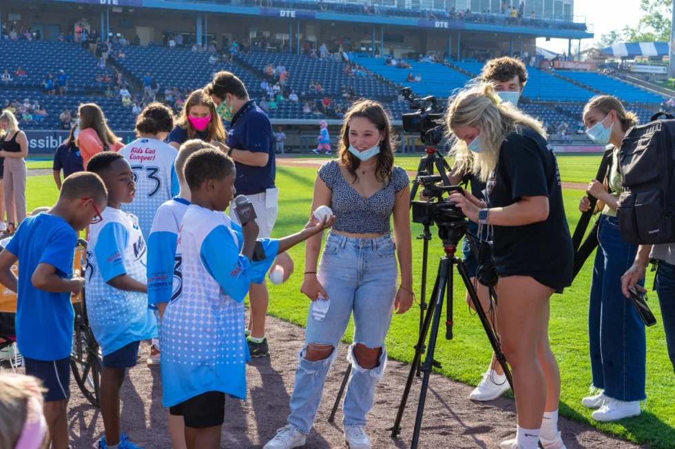 Students filming young fans at the Whitecaps game